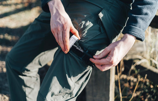 B-1 Tourniquet being applied to a patient's right leg to stop the bleeding.